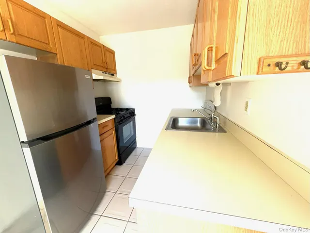 a kitchen with a sink appliances and cabinets