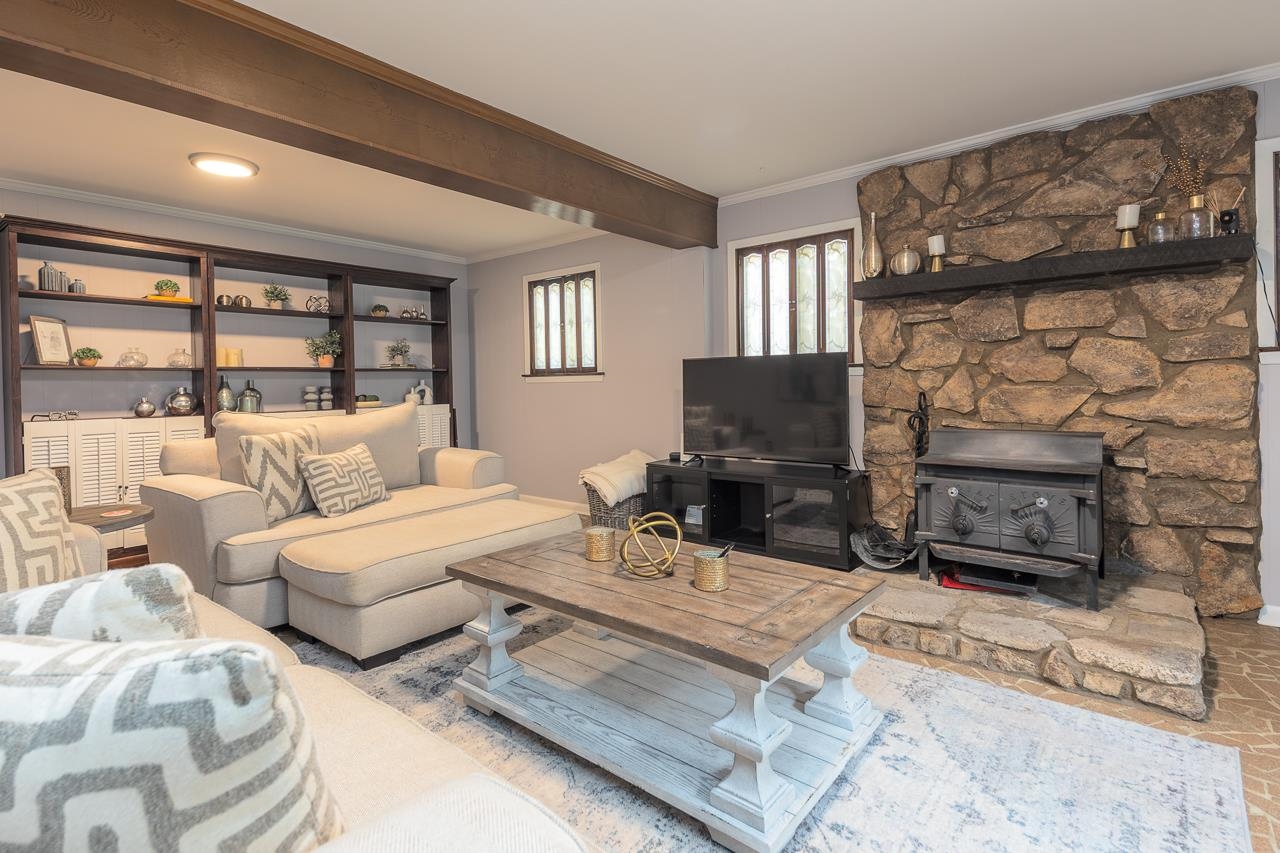 5681 Normandy Road Memphis, TN 38120 - Photo 14 of 22 a living room with furniture a fireplace and a flat screen tv