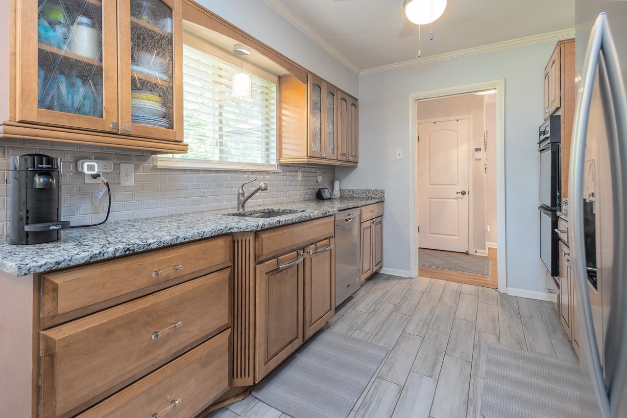 5681 Normandy Road Memphis, TN 38120 - Photo 4 of 22 a kitchen with a sink a window and stainless steel appliances