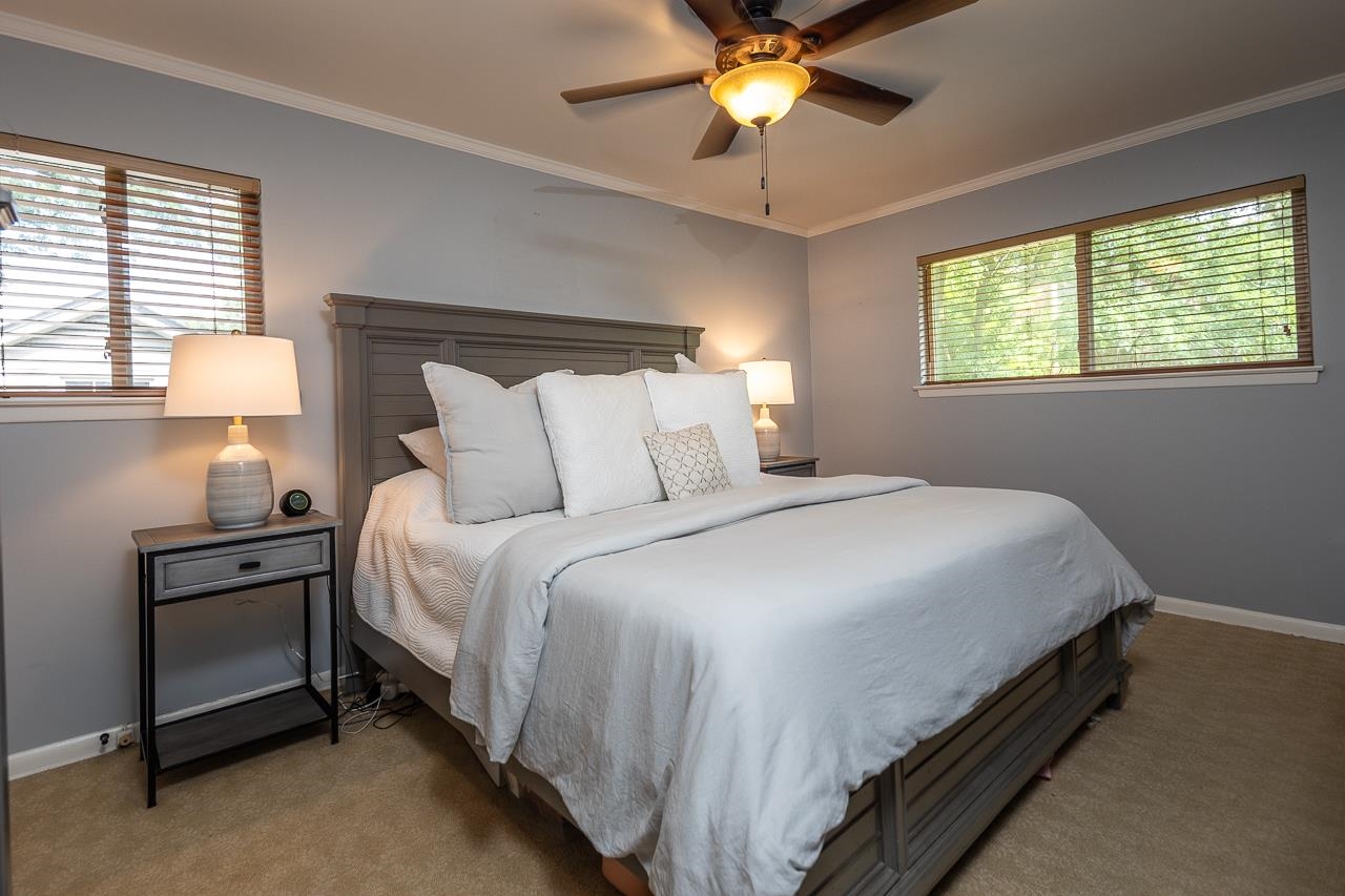 5681 Normandy Road Memphis, TN 38120 - Photo 10 of 22 a bedroom with a bed and a chandelier
