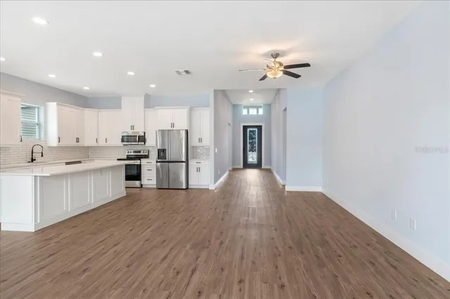 a view of kitchen with wooden floor and window