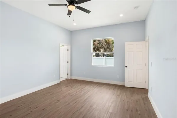 wooden floor in an empty room with a window