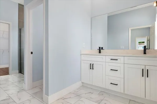 a bathroom with a sink vanity and mirror