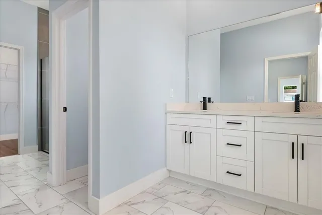 a bathroom with a sink vanity and mirror
