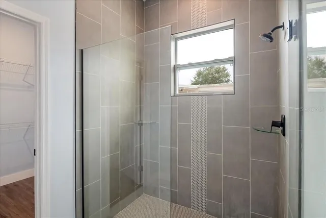 a bathroom with a window and a shower
