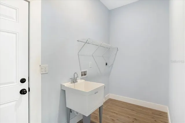 a bathroom with a sink mirror and tub