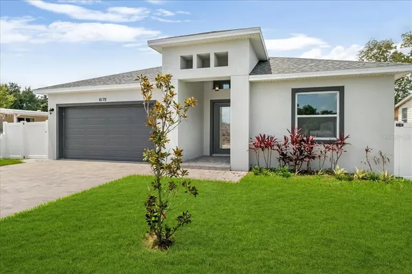 a front view of a house with a garden