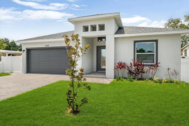a front view of a house with a garden