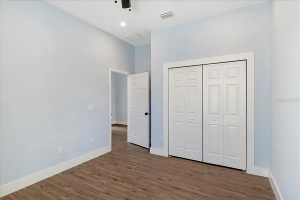 a view of an empty room with wooden floor