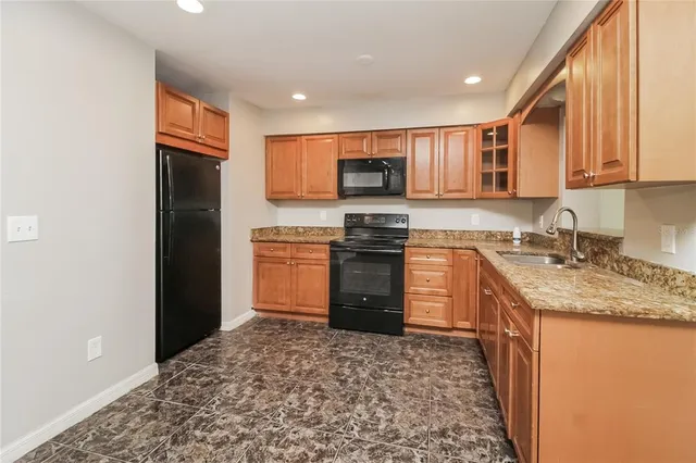 a kitchen with a sink stove and refrigerator