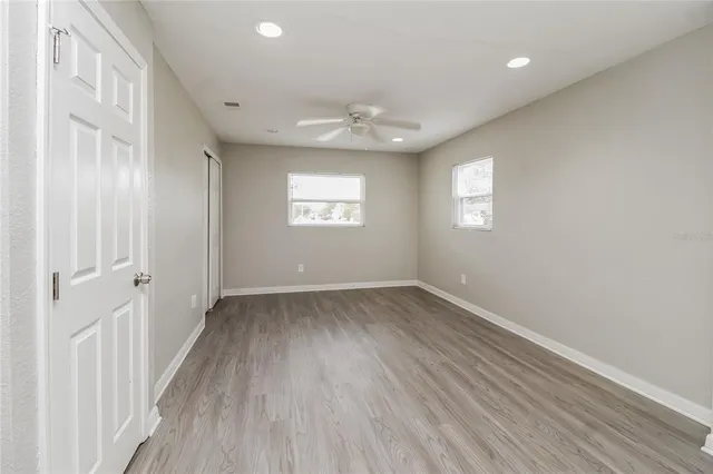 wooden floor in an empty room with a window