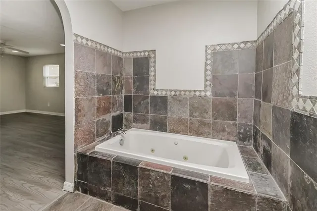 a bathroom with a bathtub and shower