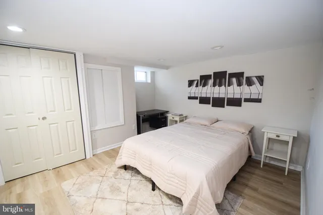 a bedroom with a bed and the view of cabinet