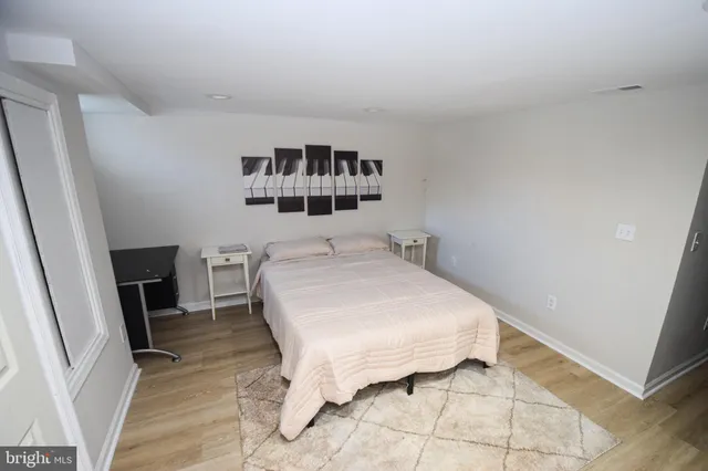 a bedroom with a bed and a night stand