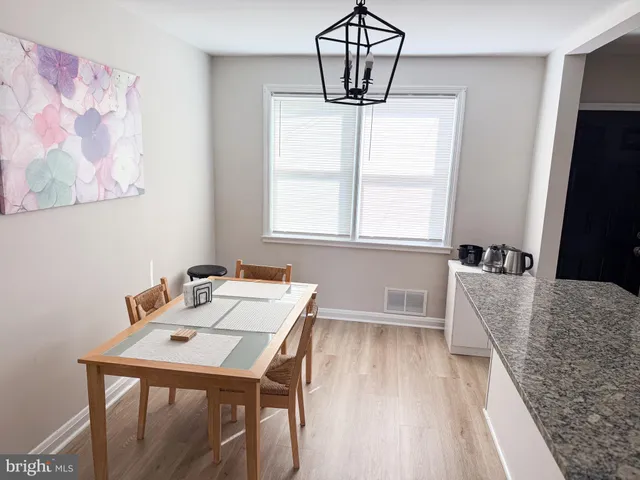 a kitchen with granite countertop white cabinets and stainless steel appliances