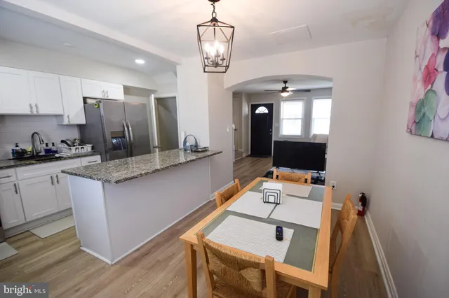 a kitchen with stainless steel appliances granite countertop a stove and a sink