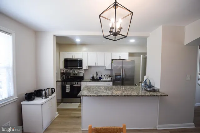 a kitchen with refrigerator a stove and a sink