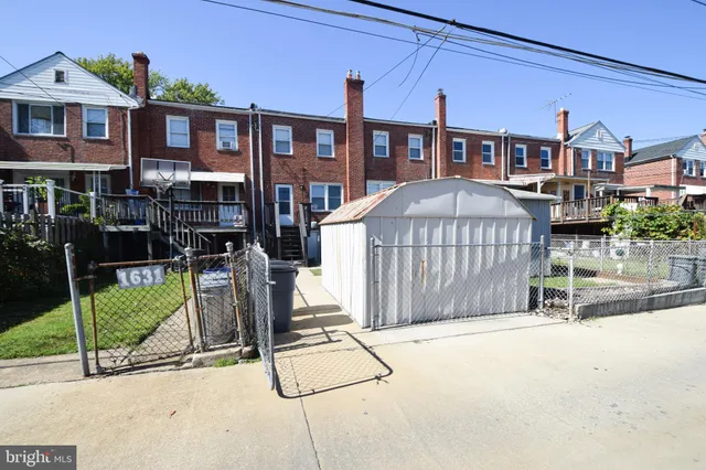 a view of a house with wooden fence