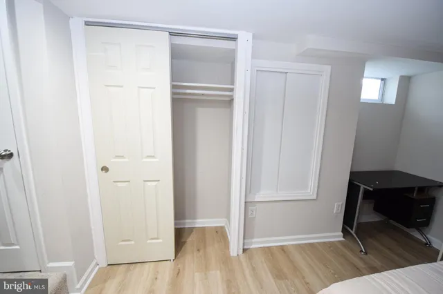 a bedroom with a bed and a mirror