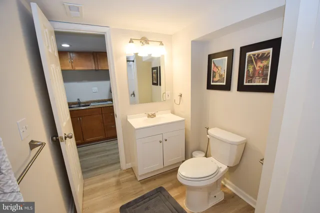 a white toilet sitting next to a bath tub