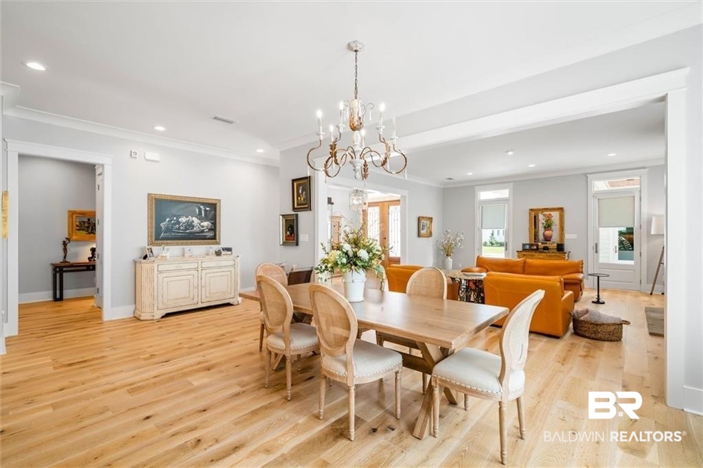 707 Cardamel Court Fairhope, AL 36532 - Photo 4 of 40 Dining room featuring a chandelier, crown molding, and light hardwood / wood-style floors