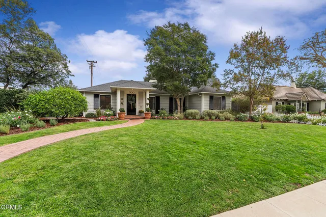 a front view of a house with a yard table and chairs