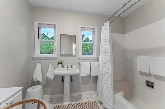 a bedroom with a large bed and a wooden floor