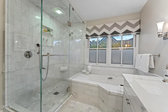 a spacious bedroom with a large bed and a flat screen tv