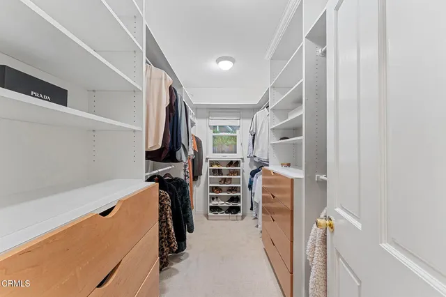 a view of a patio with couches table and chairs under an umbrella