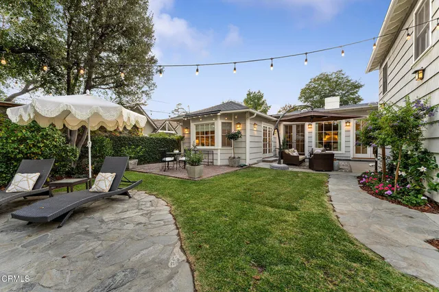 a living room with furniture and kitchen view