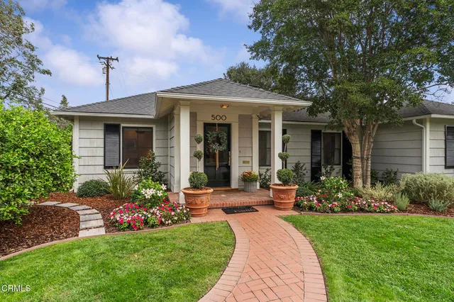 a front view of a house with garden