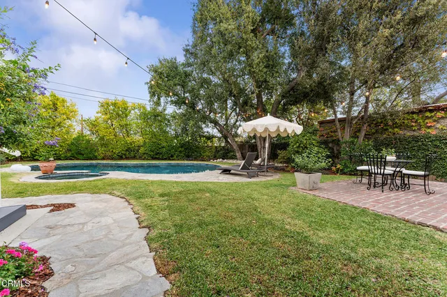 a front view of a house with patio and garden