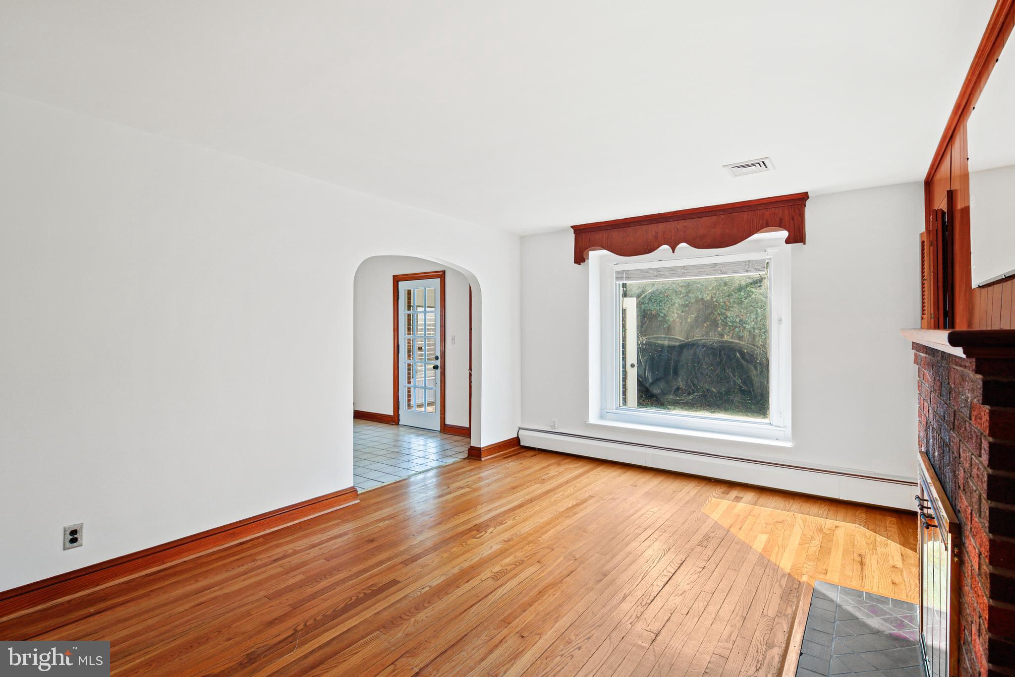 4763 Linthicum Road Dayton, MD 21036 - Photo 9 of 39 Hardwood flooring and large window in living room