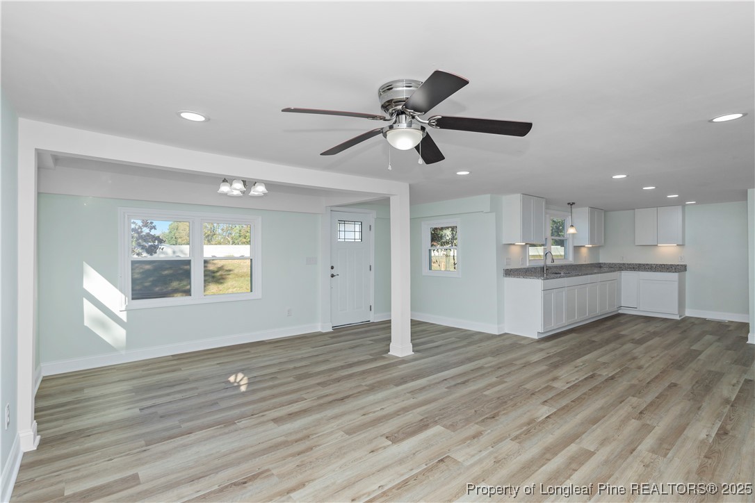 1340 George Perry Lee Road Dunn, NC 28334 - Photo 13 of 31 a view of an empty room with window and wooden floor