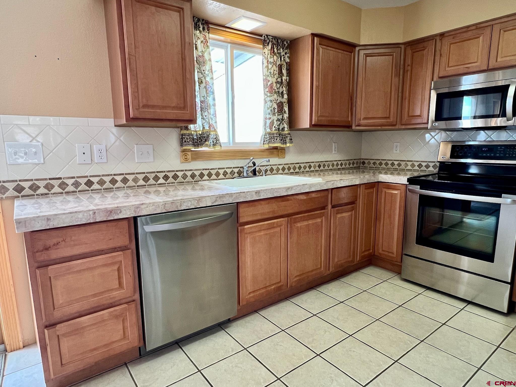 485 1740th Road Delta, CO 81416 - Photo 12 of 37 a kitchen with stainless steel appliances granite countertop a stove microwave and cabinets