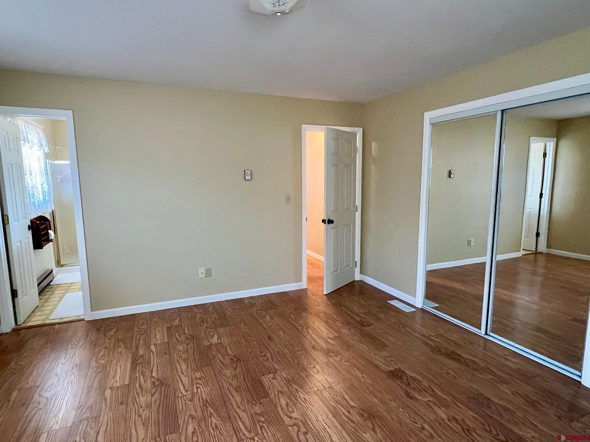 485 1740th Road Delta, CO 81416 - Photo 18 of 37 a view of an empty room with wooden floor and a window
