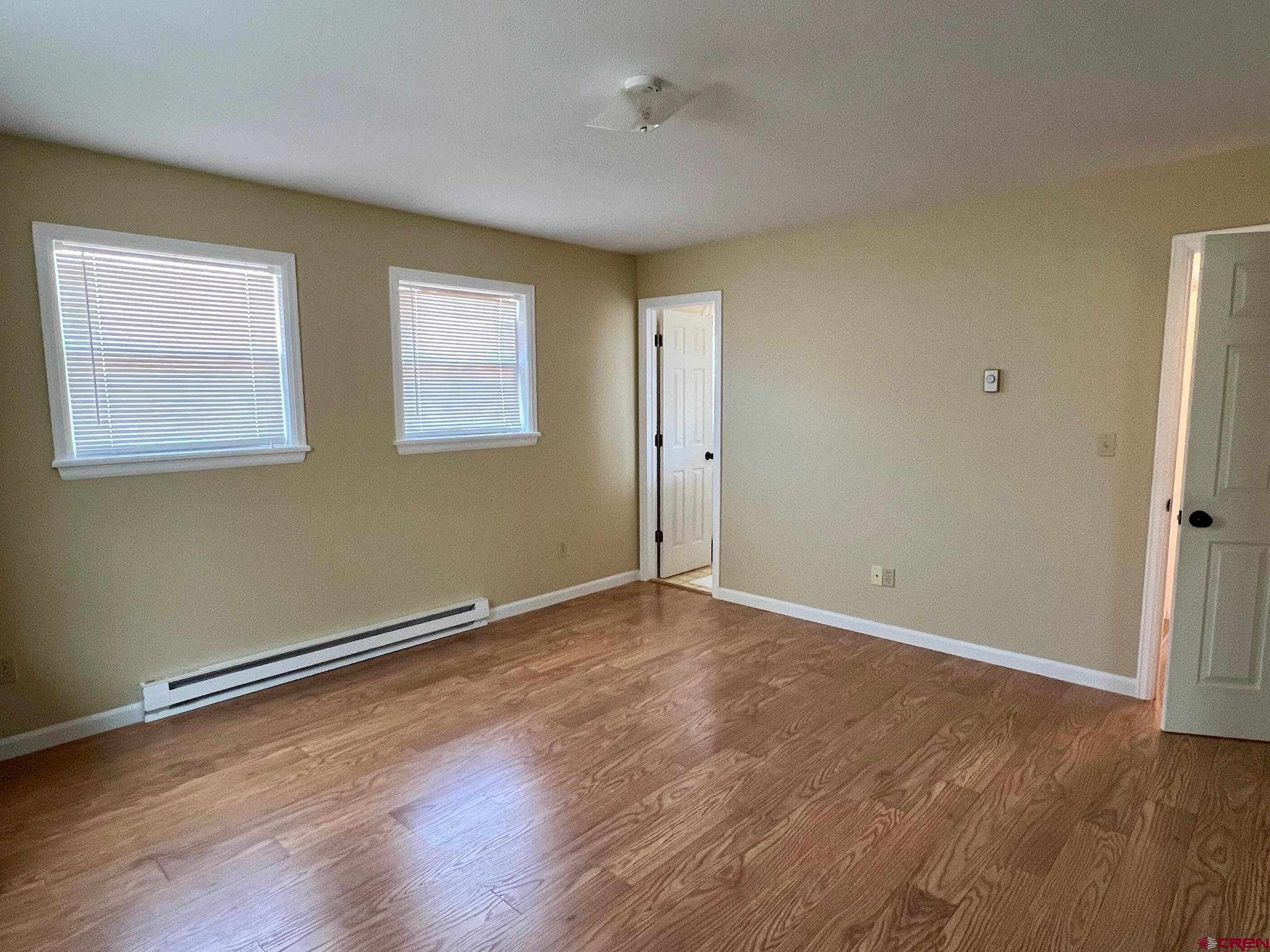 485 1740th Road Delta, CO 81416 - Photo 20 of 37 an empty room with wooden floor and windows