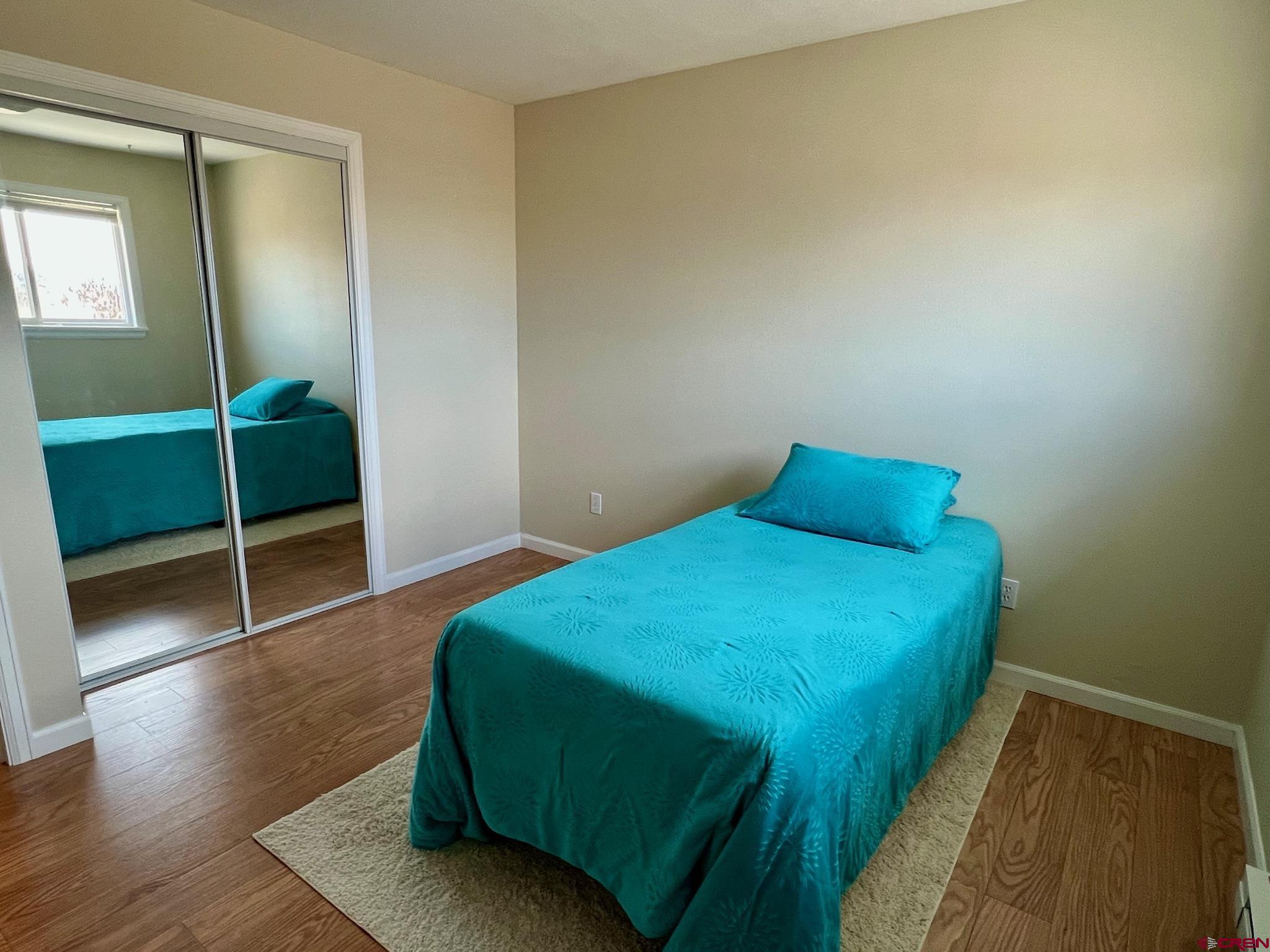 485 1740th Road Delta, CO 81416 - Photo 23 of 37 a bedroom with a bed and a wooden floor