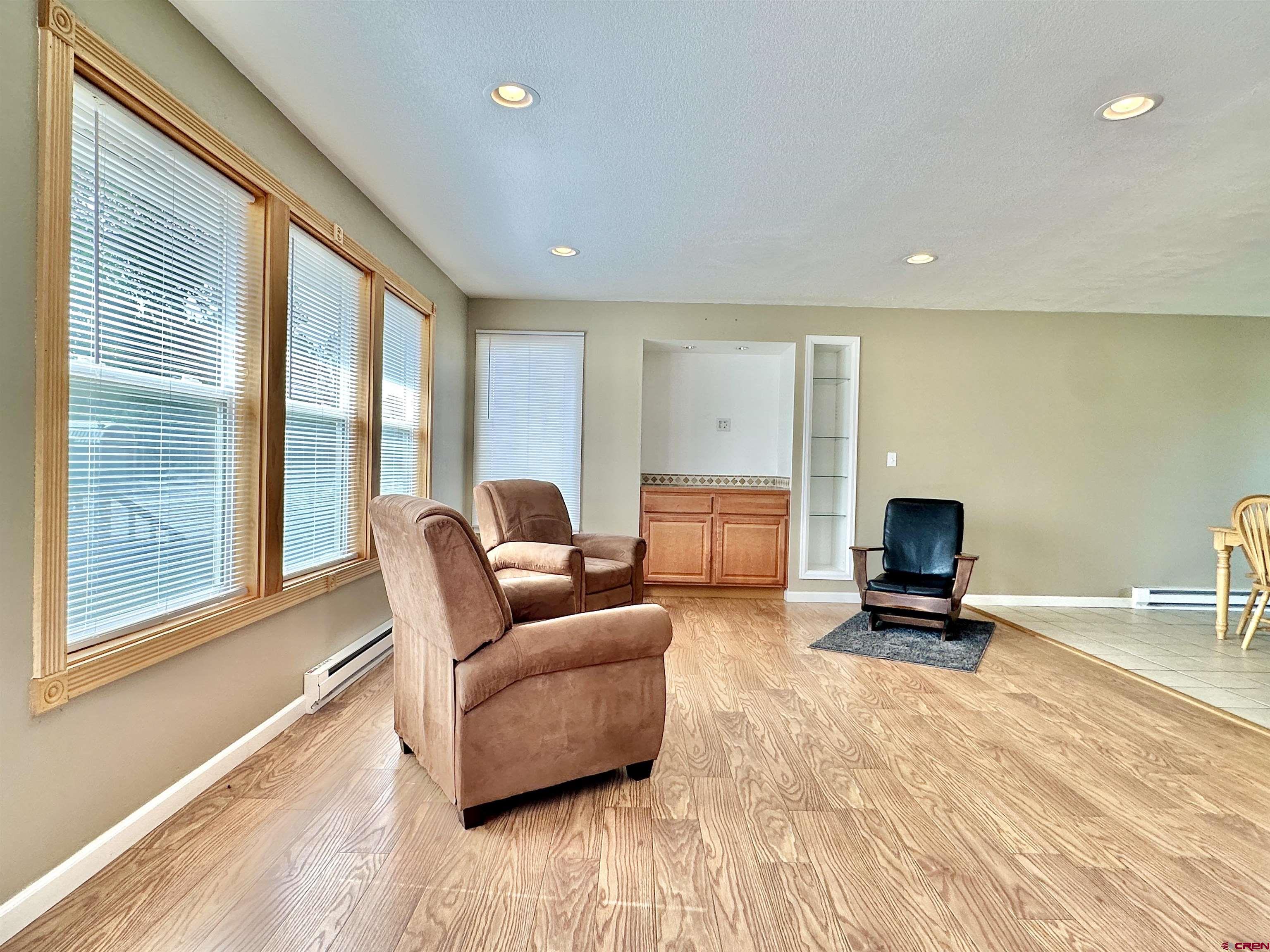 485 1740th Road Delta, CO 81416 - Photo 5 of 37 a living room with furniture a flat screen tv and a large window