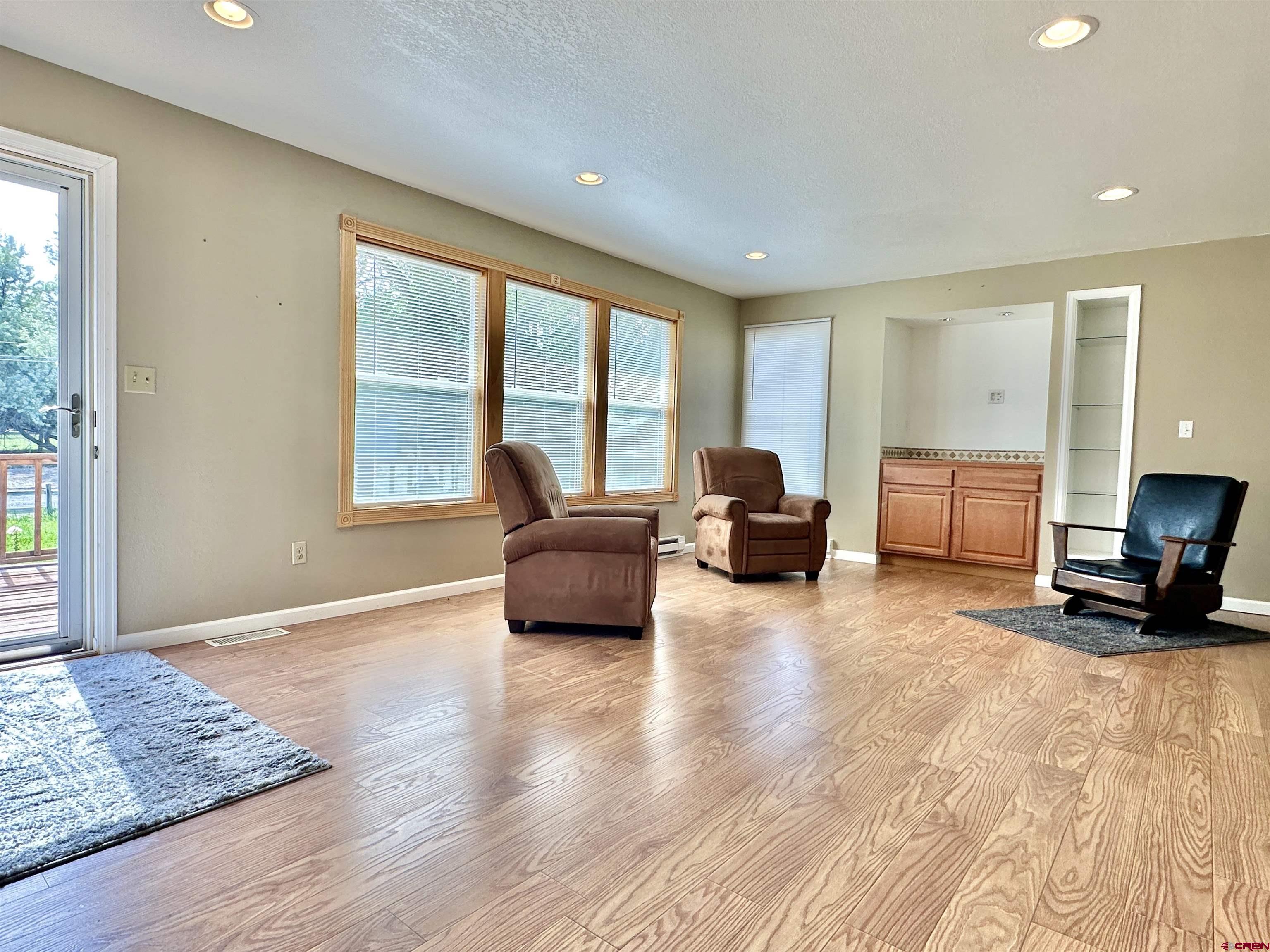 485 1740th Road Delta, CO 81416 - Photo 6 of 37 a living room with furniture and a flat screen tv