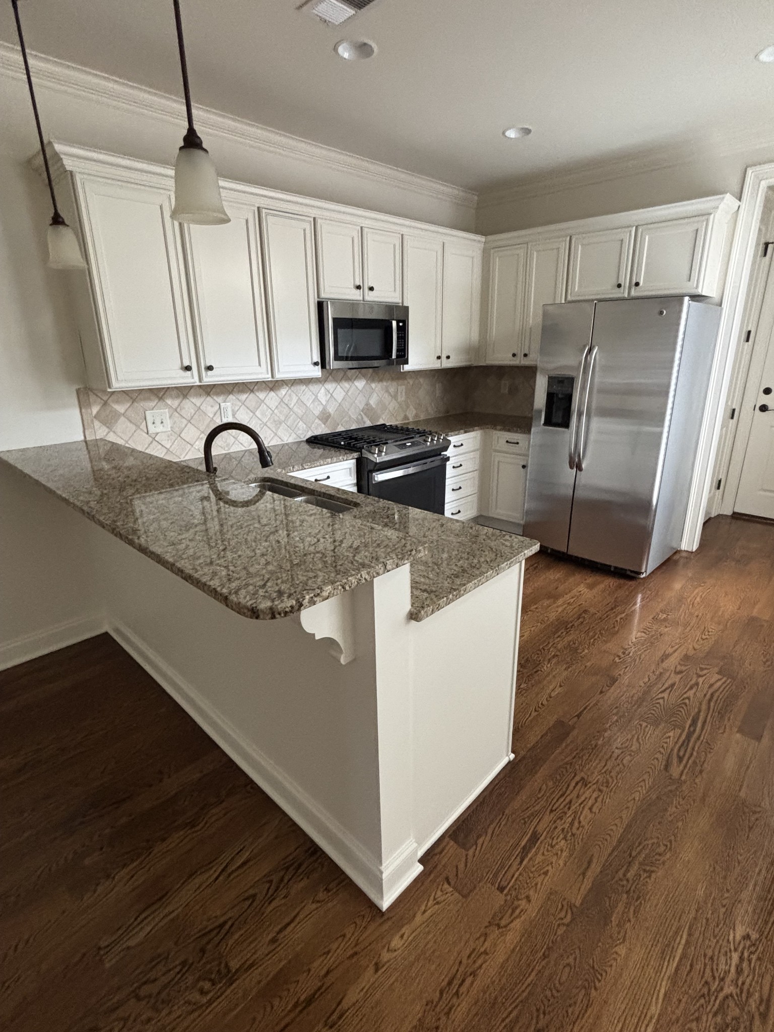 373 Byron Way Franklin, TN 37064 - Photo 2 of 15 a kitchen with granite countertop a sink a stove a refrigerator and cabinets