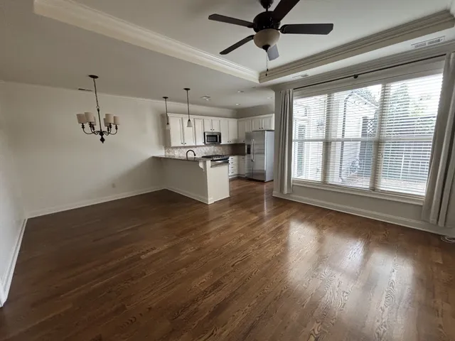 a view of a kitchen with a sink and wooden floor