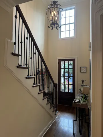 a view of entryway and hall with wooden floor