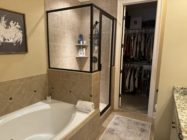 a bathroom with a bathtub and a shower