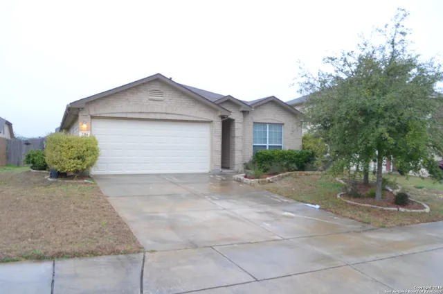 a view of a house with a yard and garage