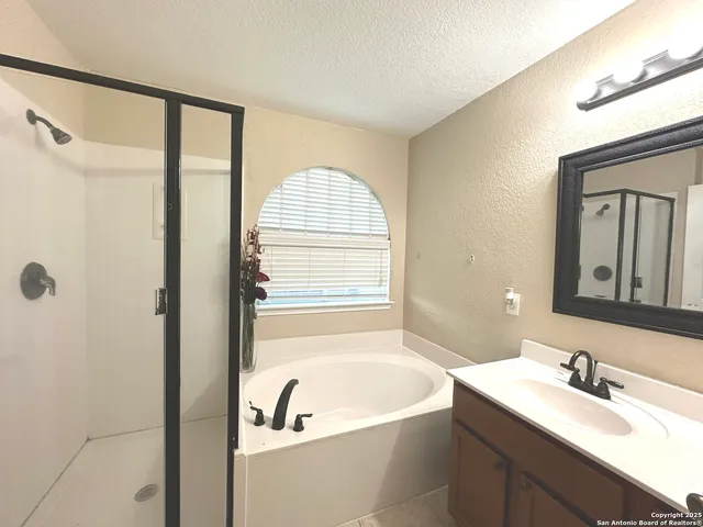 an empty room with a window and ceiling fan