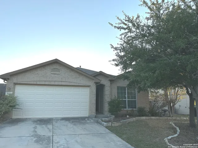 an empty room with windows and ceiling fan