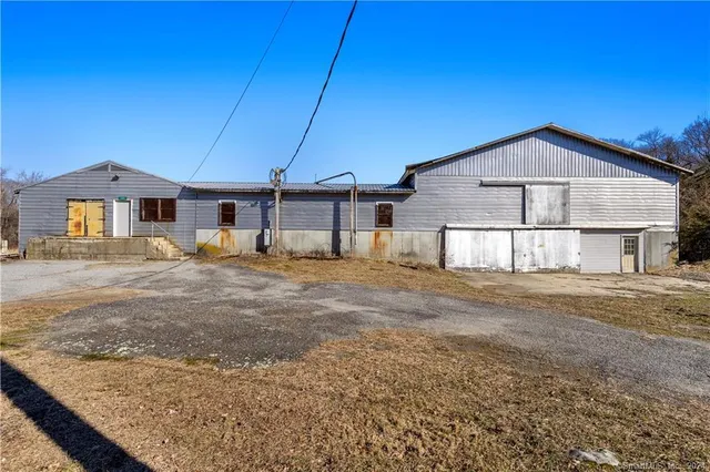 a view of a swimming pool with outdoor seating and a yard