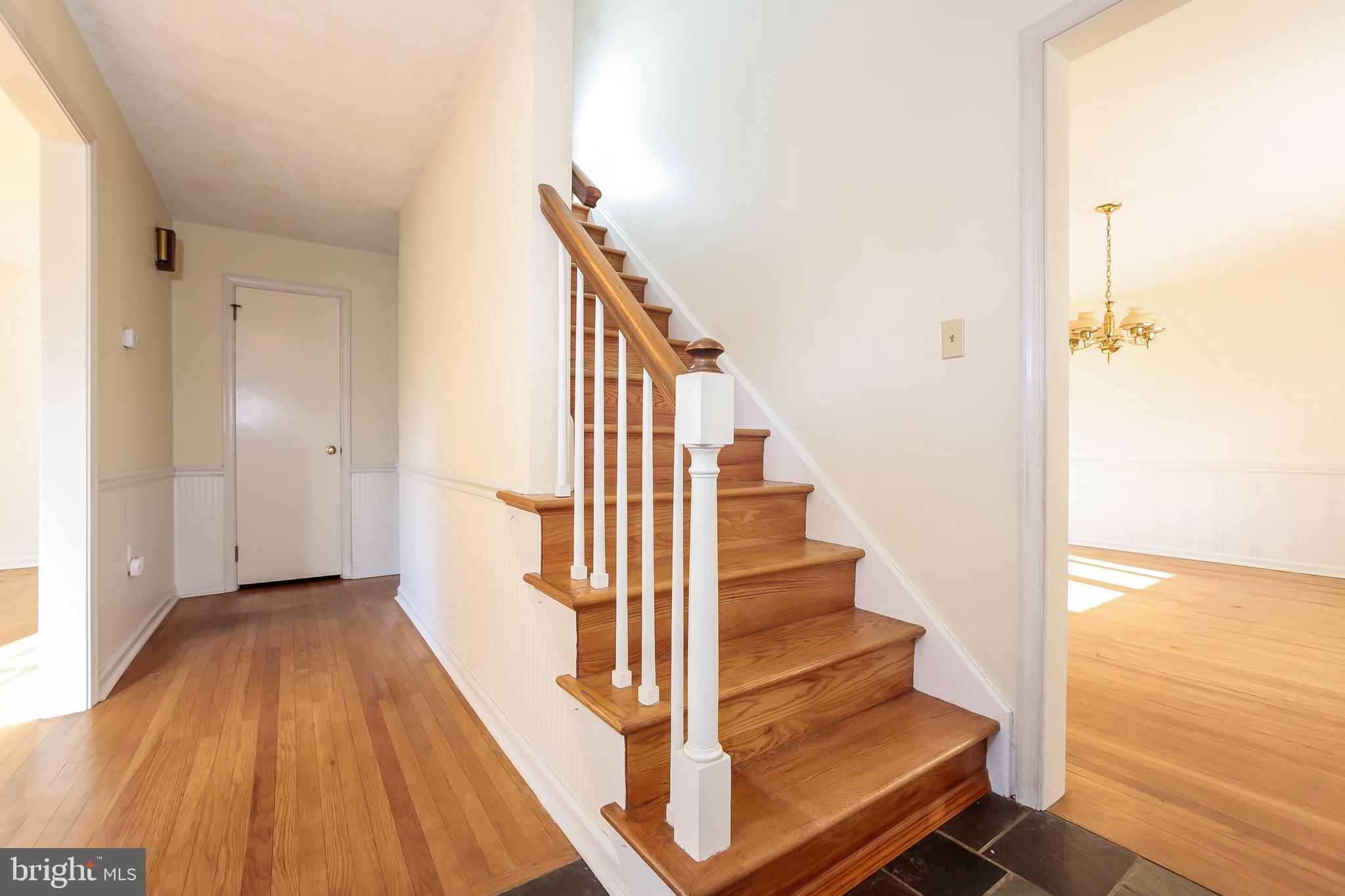 Slate Entry With Hardwood Flooring Throughout