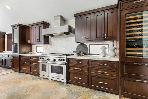 a kitchen with stainless steel appliances granite countertop a stove and a refrigerator